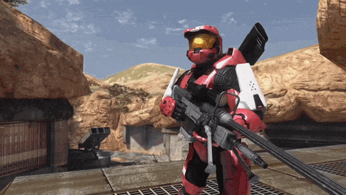 a man in a red helmet holding a gun