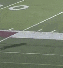 a football player with the number 18 on his back stands on the field