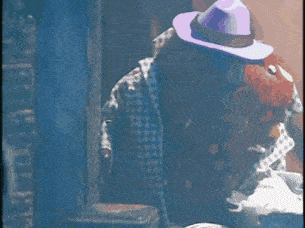 a man wearing a purple hat and sunglasses
