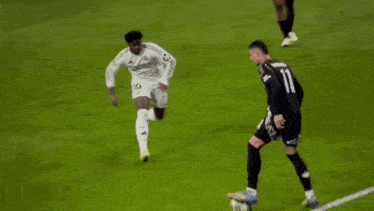 a soccer player with the number 11 on his jersey is running on the field .