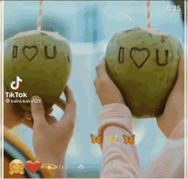 two people holding coconuts with the words i love you on them
