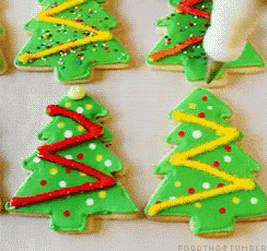 a bunch of green christmas trees with red yellow and white decorations