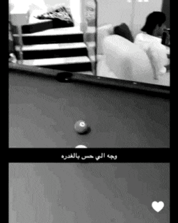 a black and white photo of a pool table in a living room