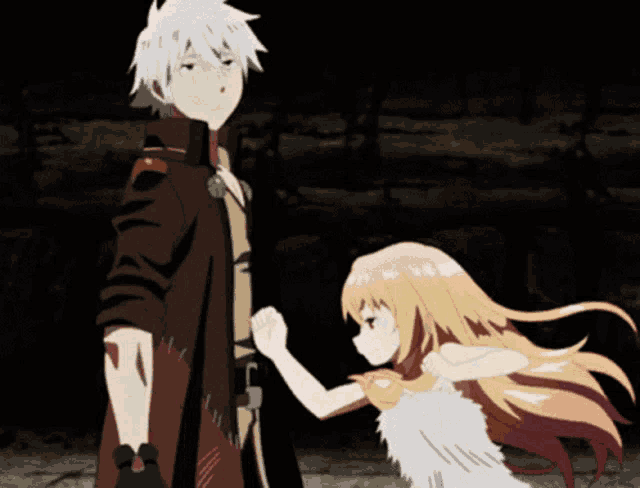 a boy and a girl are standing next to each other in a dark room