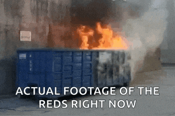 a blue dumpster is on fire with the words actual footage of the reds right now above it
