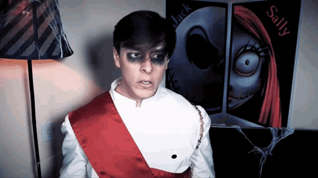 a man is standing in front of a nightmare before christmas poster of jack and sally