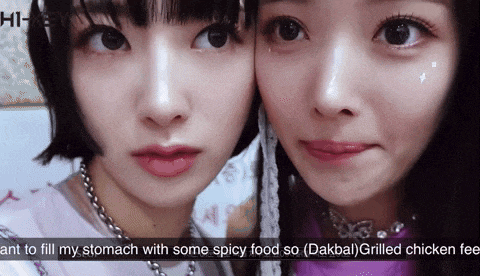 two girls are looking at the camera with the caption ant to fill my stomach with some spicy food so