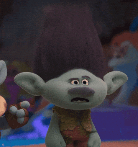 a troll with a surprised look on his face is holding a ring