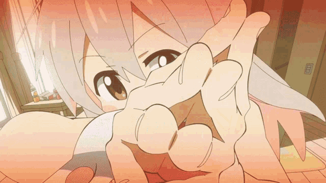 a girl with pink hair is covering her face with her hand
