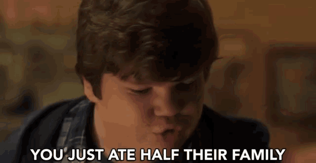 a young boy is eating a piece of food and says you just ate half their family .