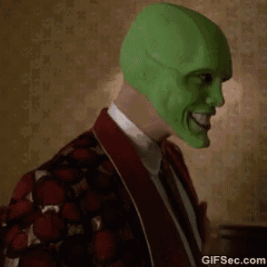 a man is wearing a green mask and a red robe .