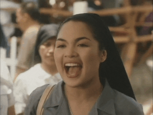 a woman is making a funny face with her mouth open