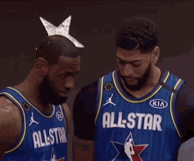 lebron james and anthony davis are posing for a picture in their all star jerseys