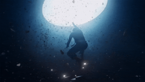 a silhouette of a person standing in a cave