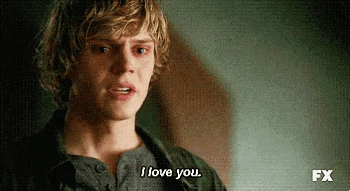 a close up of a man 's face with the words `` i love you '' written on the bottom