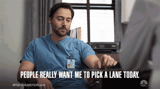 a man in scrubs is sitting in a chair and says people really want me to pick a lane today nbc