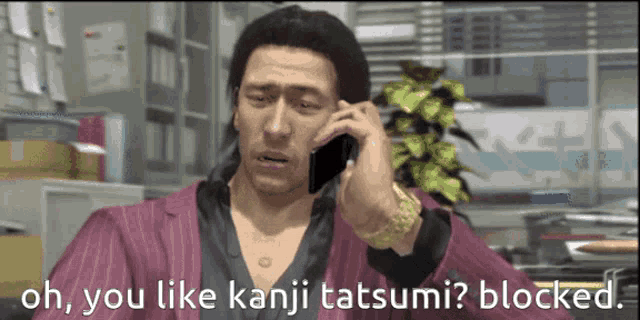 a man is talking on a cell phone with the words oh you like kanji tatsumi blocked below him
