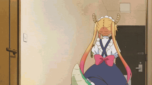 a girl with horns and a pink bow is standing in a room