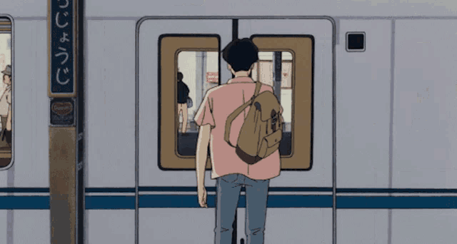 a man with a backpack is standing in front of a train with a sign that says ' strawberry ' on it