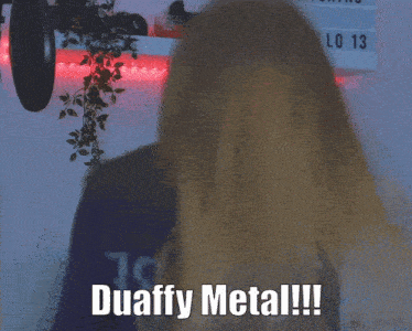 a woman making a horn sign with the words duaffy metal written below her