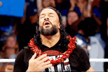 a wrestler wearing a lei and a shirt that says ' i 'm a hawaiian ' on it