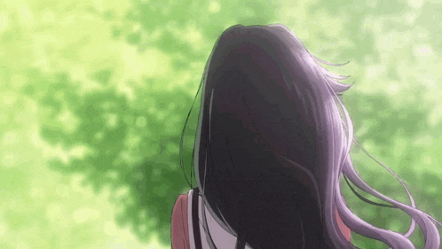 a woman with long purple hair is standing in front of a green forest .
