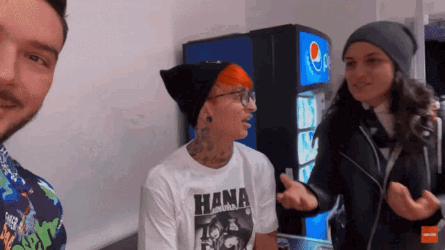 a man wearing a hana shirt is talking to a woman