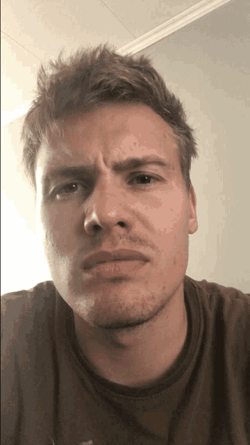 a close up of a man 's face with a serious expression