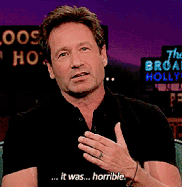 a man says " it was horrible " in front of a sign that says " the broadway holly "
