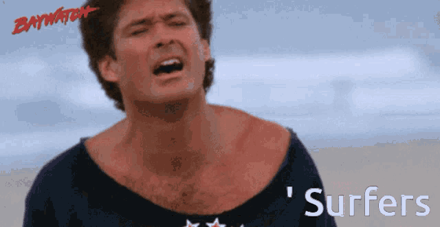 a man with the word surfers on the bottom of his shirt