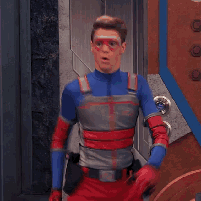 a man in a superhero costume is holding a door knob
