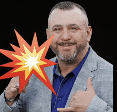 a man in a suit is giving a thumbs up while holding a red and yellow star in front of his face
