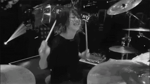 a man playing drums in a black and white photo