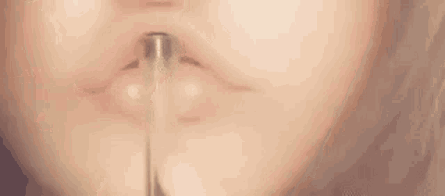 a close up of a woman 's lips with long hair .