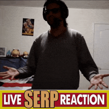 a man wearing headphones stands in front of a sign that says " live serp reaction "