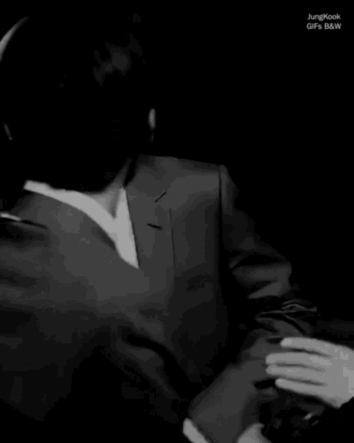 a man in a suit and tie is laughing with another man in a suit and tie