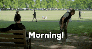 a man is sitting on a bench in a park with the words morning written on it