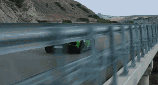 a green lamborghini is driving on a highway with a license plate that says tf-pz-eei
