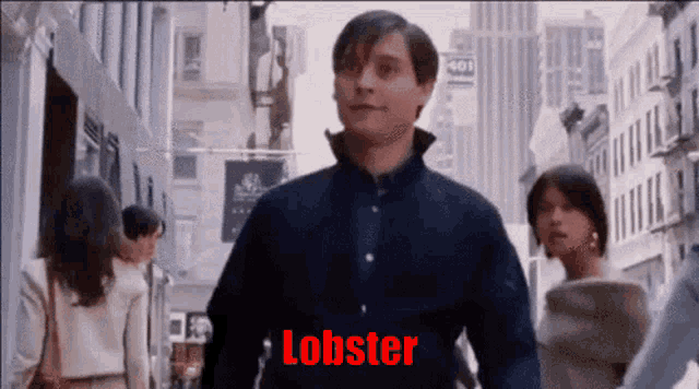 a man is walking down a street with the word lobster written on his chest