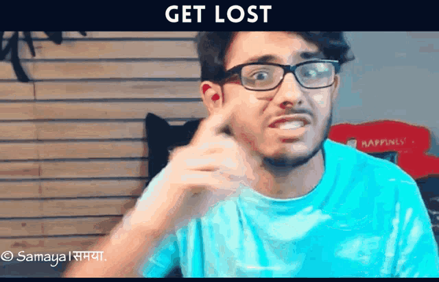 a man wearing glasses and a blue shirt is making a funny face and says get lost