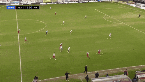 a soccer game is being played with a score of 1-0