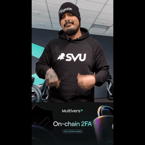 a man wearing a svu hoodie stands in front of an ad for multiverse on-chain 2fa