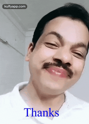 a man with a mustache is making a funny face with the words thanks written below him .