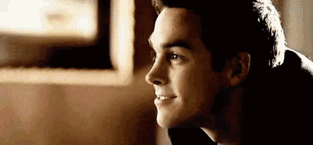 a close up of a man 's face with a smile on it .
