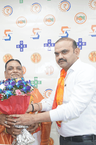 a man is giving a woman a bouquet of flowers in front of a wall that says one on it