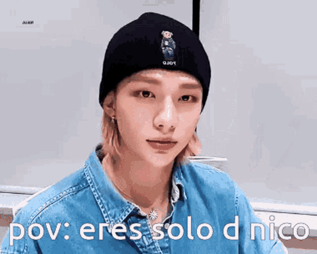 a young man wearing a black beanie and a denim shirt with the words pov : eres solo d nico below him .
