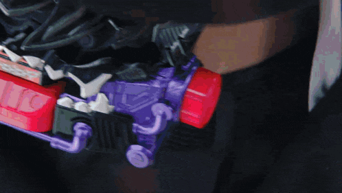 a close up of a person 's face with a purple item in the background