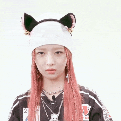 a girl with pink hair wearing a white hat with ears