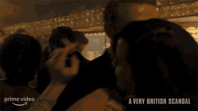 a man in a tuxedo is being touched by a woman in a prime video advertisement