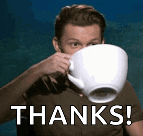 a man is drinking from a very large cup with the words thanks written on the bottom